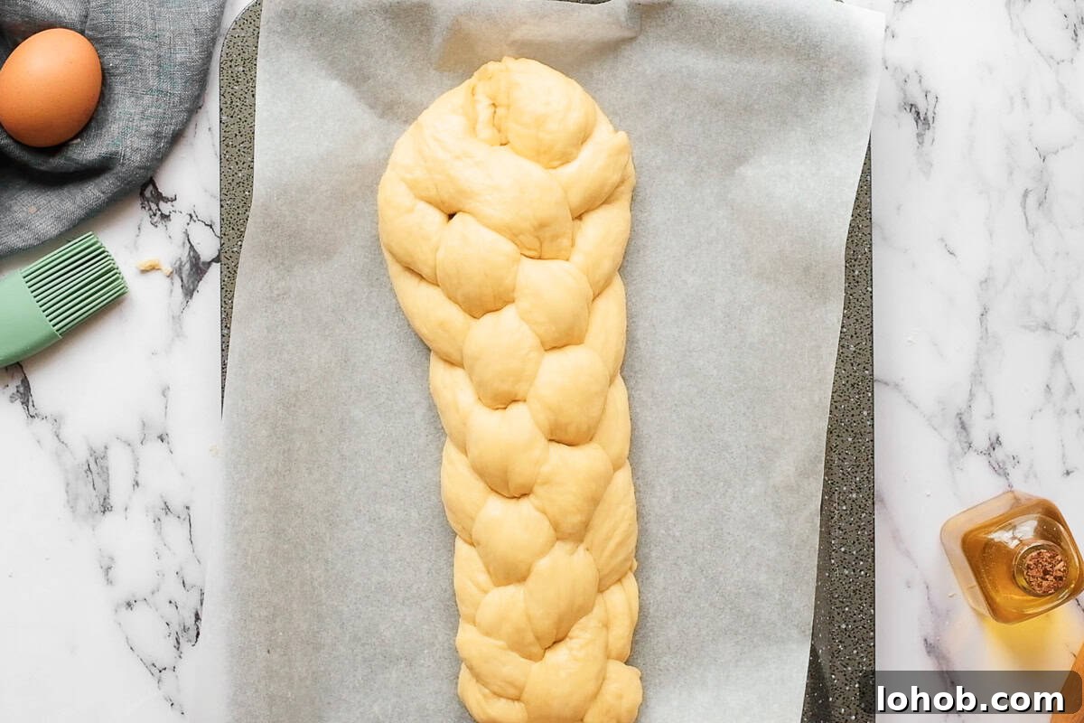 letting braided loaf of homemade challah bread dough rise.
