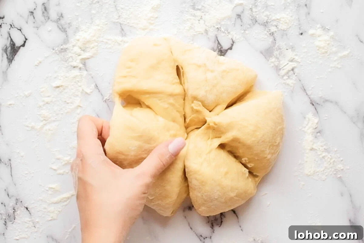 cutting homemade challah bread dough into six pieces.