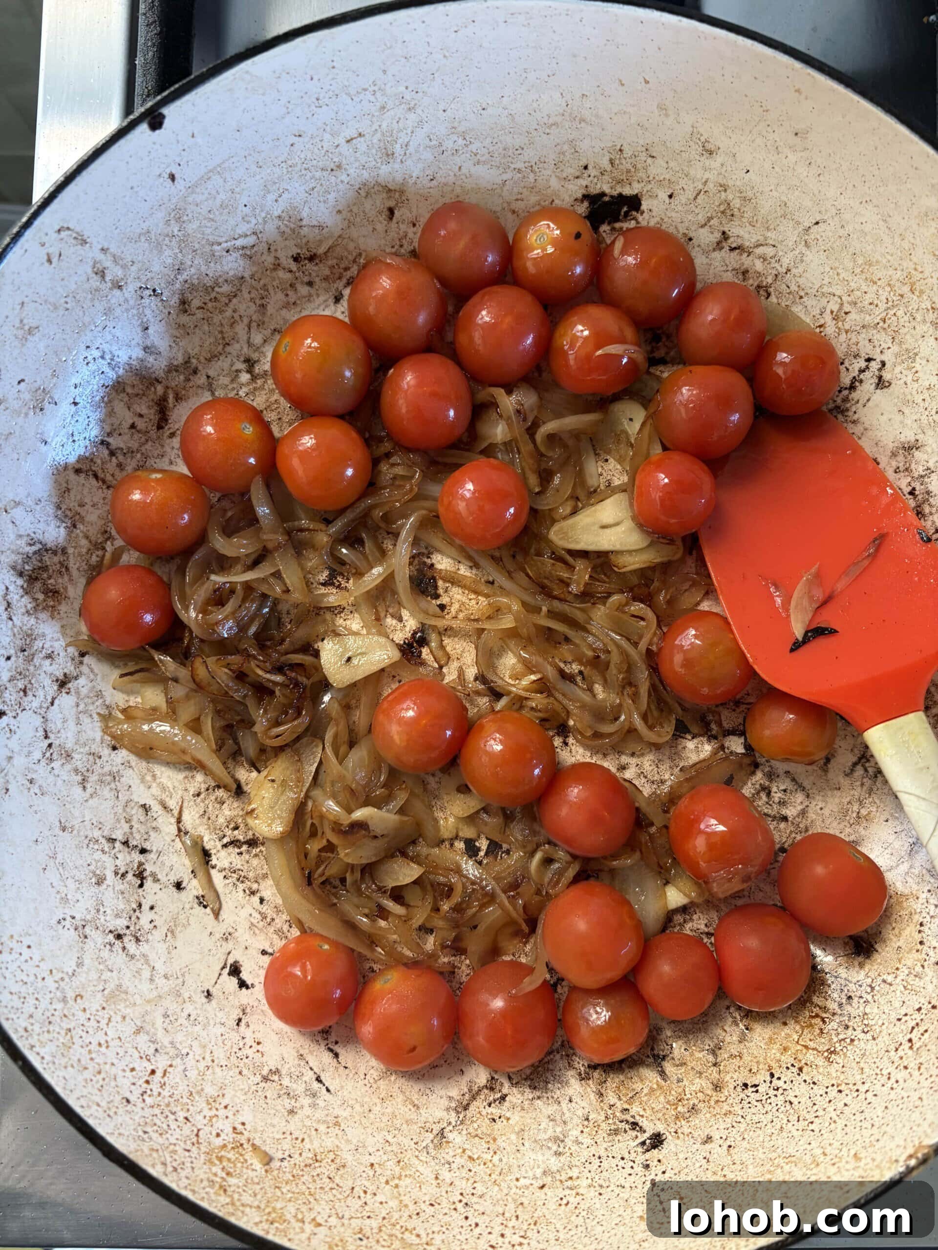 adding tomatoes to onions.