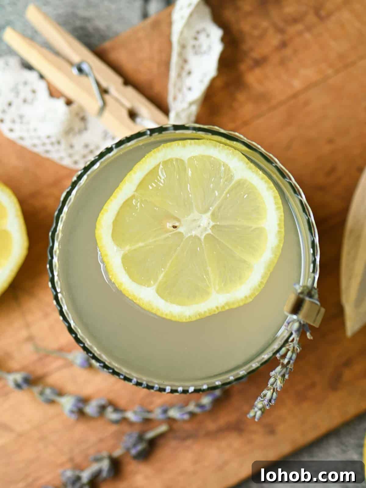 Overhead of lemonade in a glass with a straw.