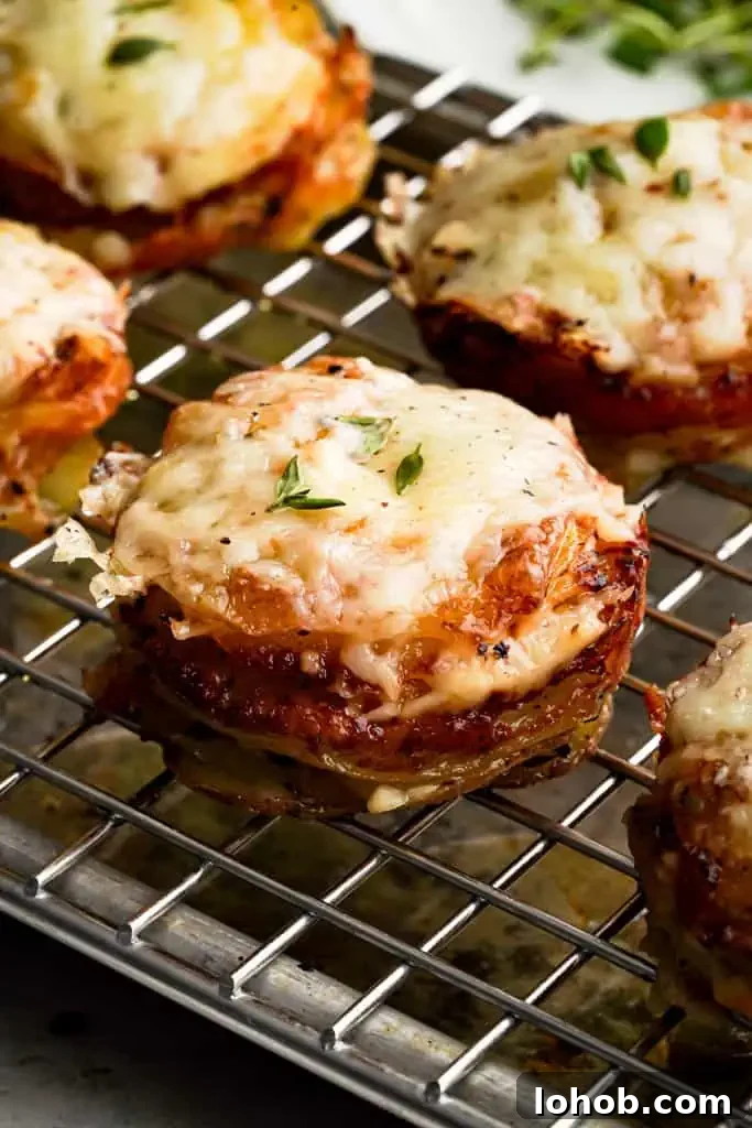 close up view of cheesy potato stacks on a rack