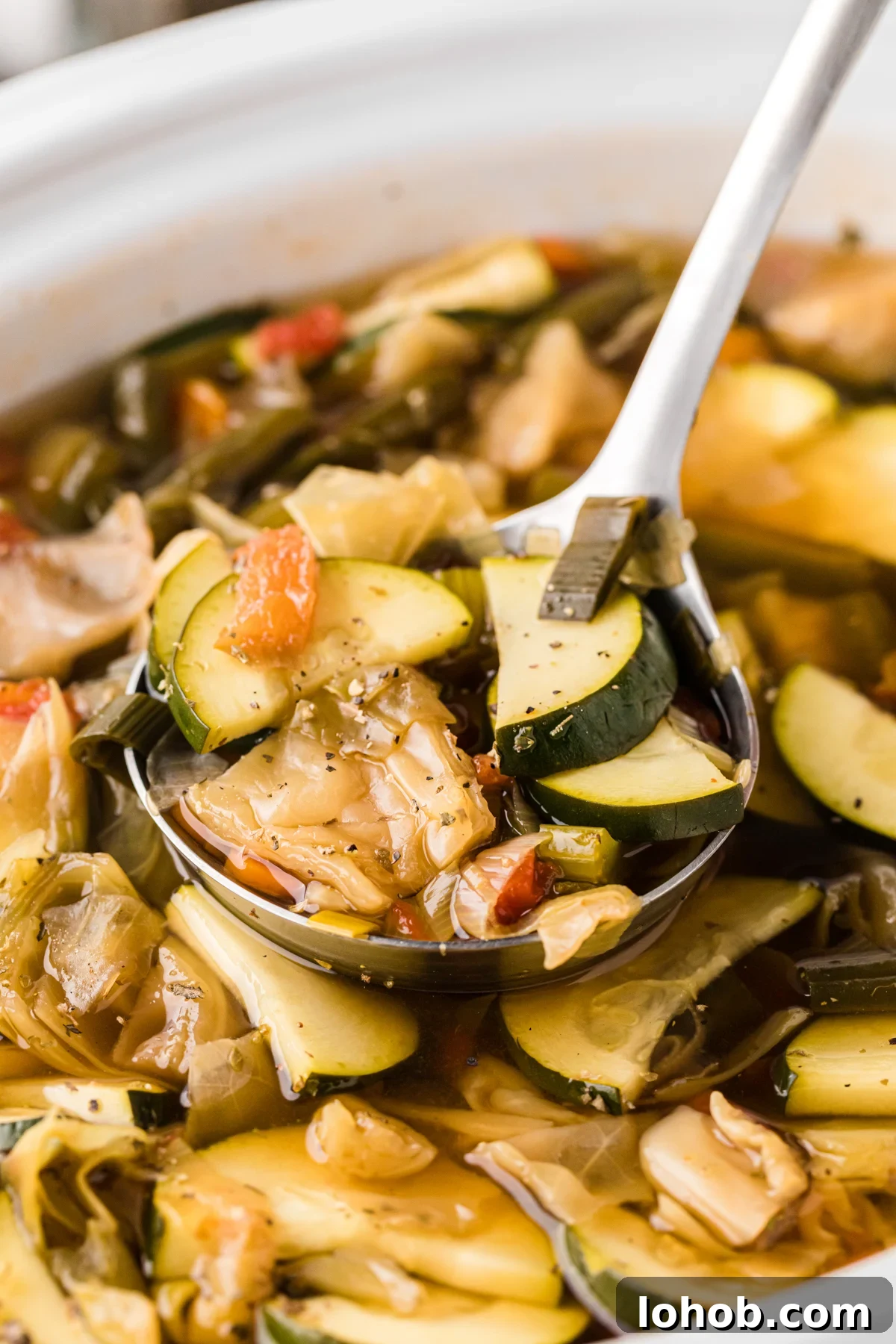 Metabolism-Boosting Vegetable Soup for Fast Weight Loss 2 Close-up of slow cooker weight loss soup with a ladle.