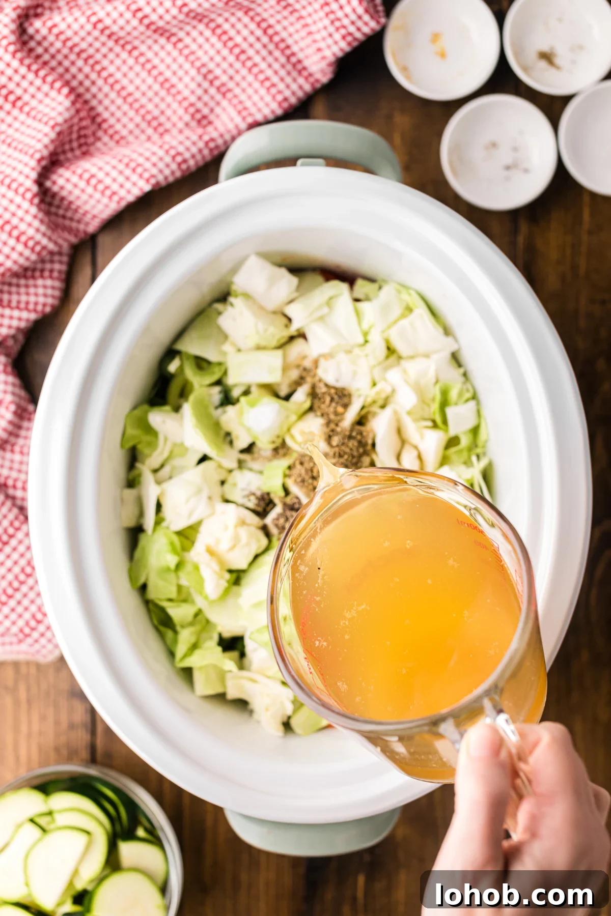 Metabolism-Boosting Vegetable Soup for Fast Weight Loss 5 Pouring chicken broth into a crockpot.