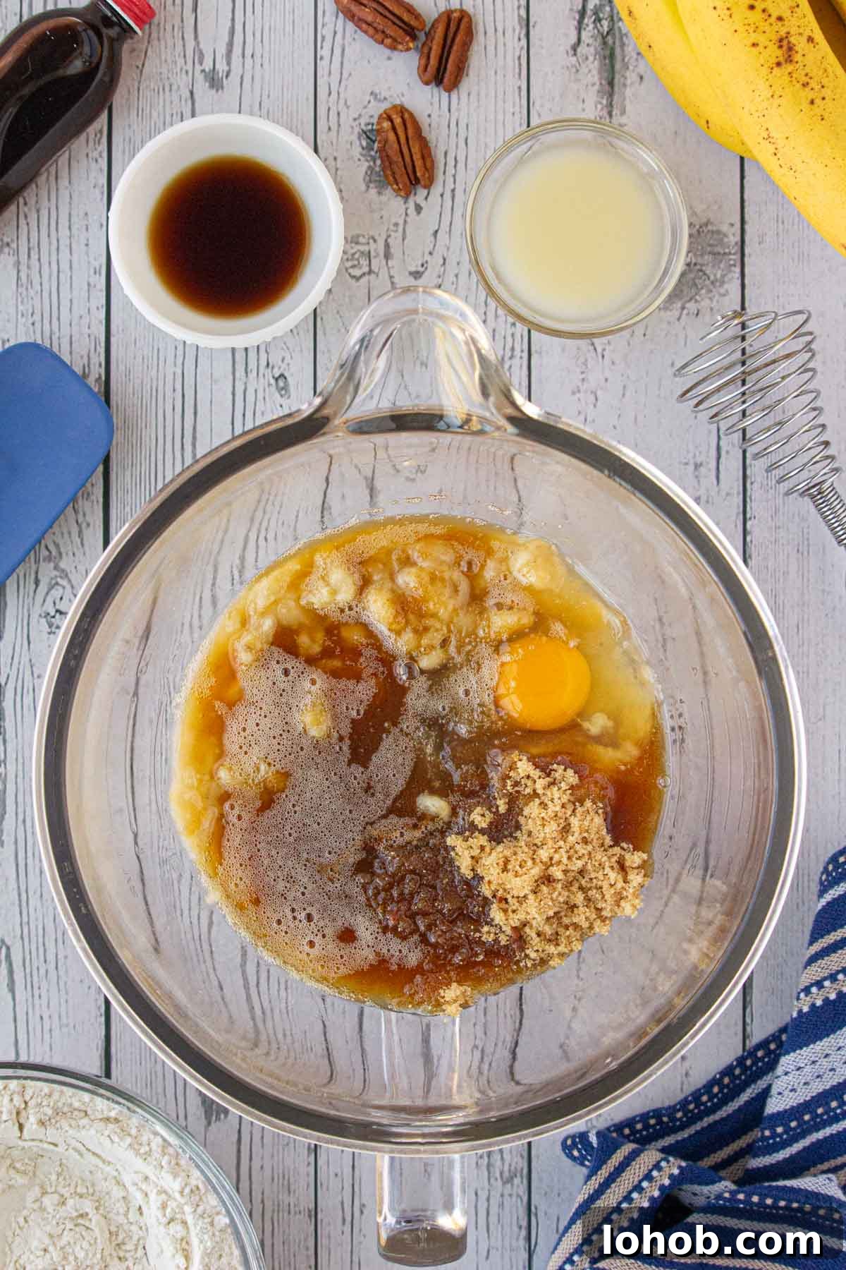 The wet ingredients combined with mashed bananas.