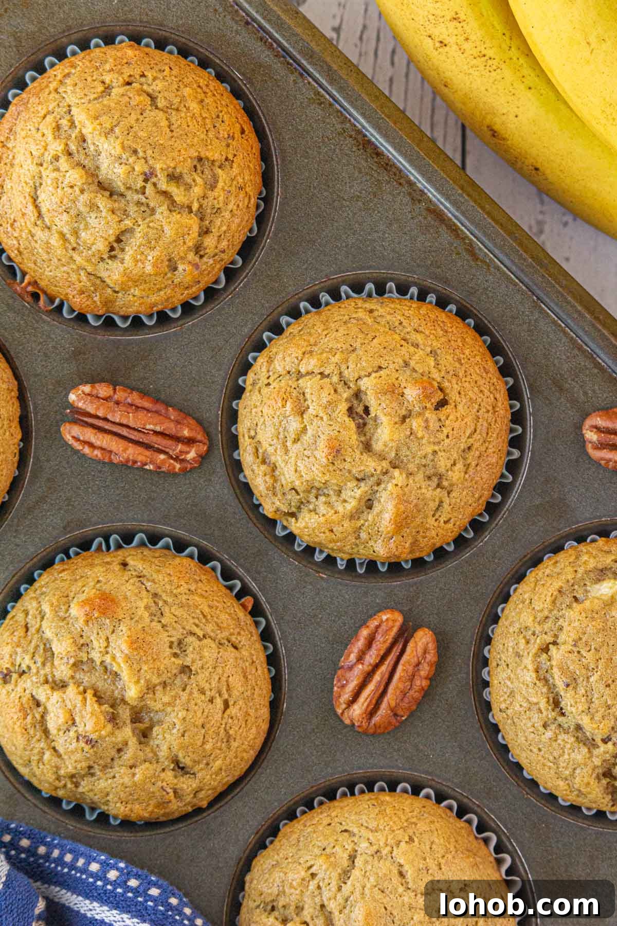 A close-up, overhead view of the brown butter banana pecan muffins in a muffin tin.