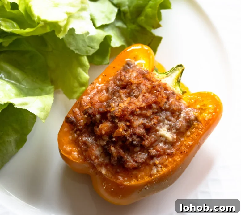 Close up of a stuffed bell pepper with ground beef and rice.