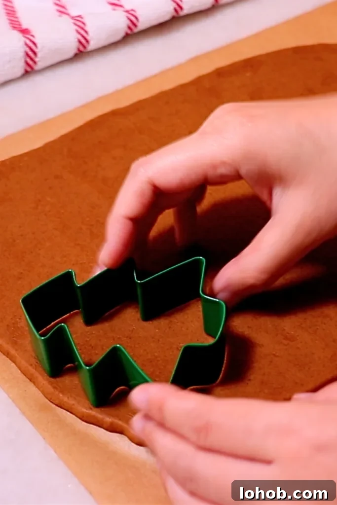 cutting gingerbread cookie dough with a cookie cutter