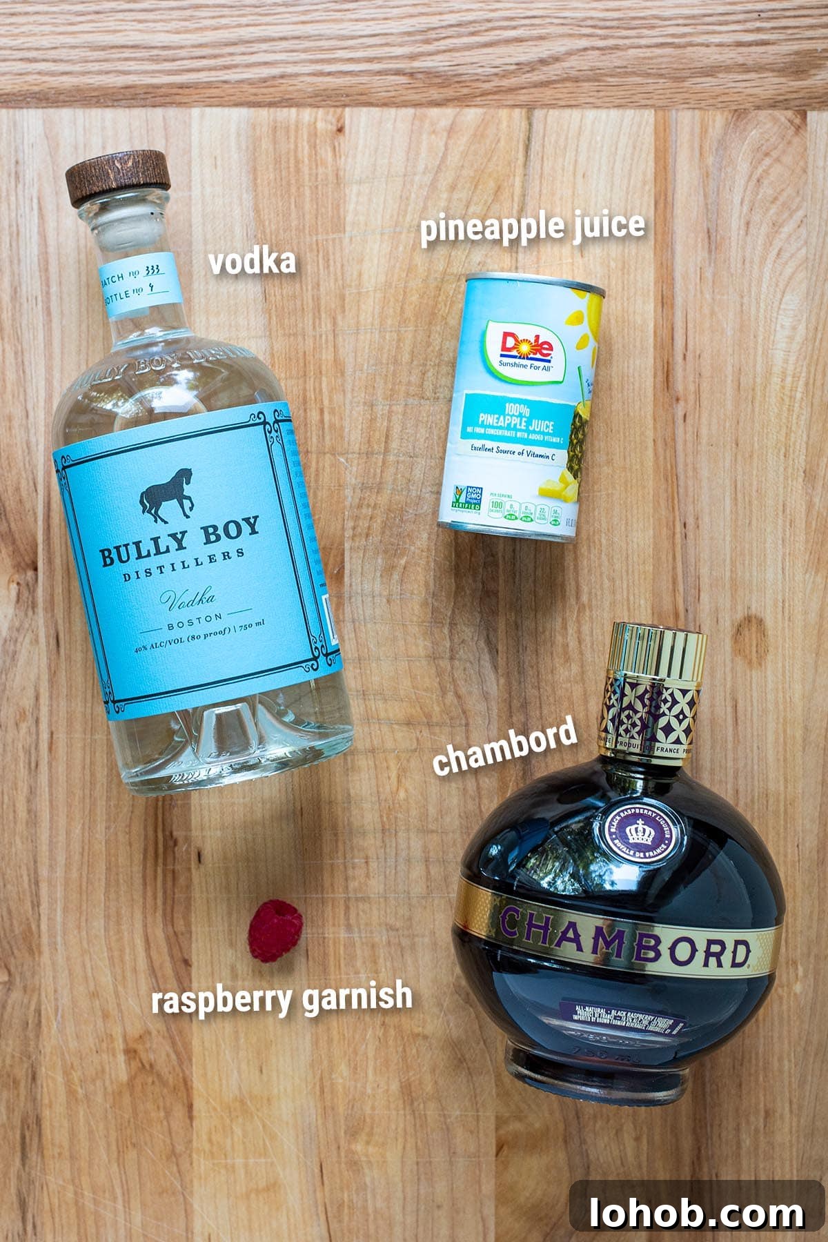 French Martini cocktail ingredients on a wooden table.