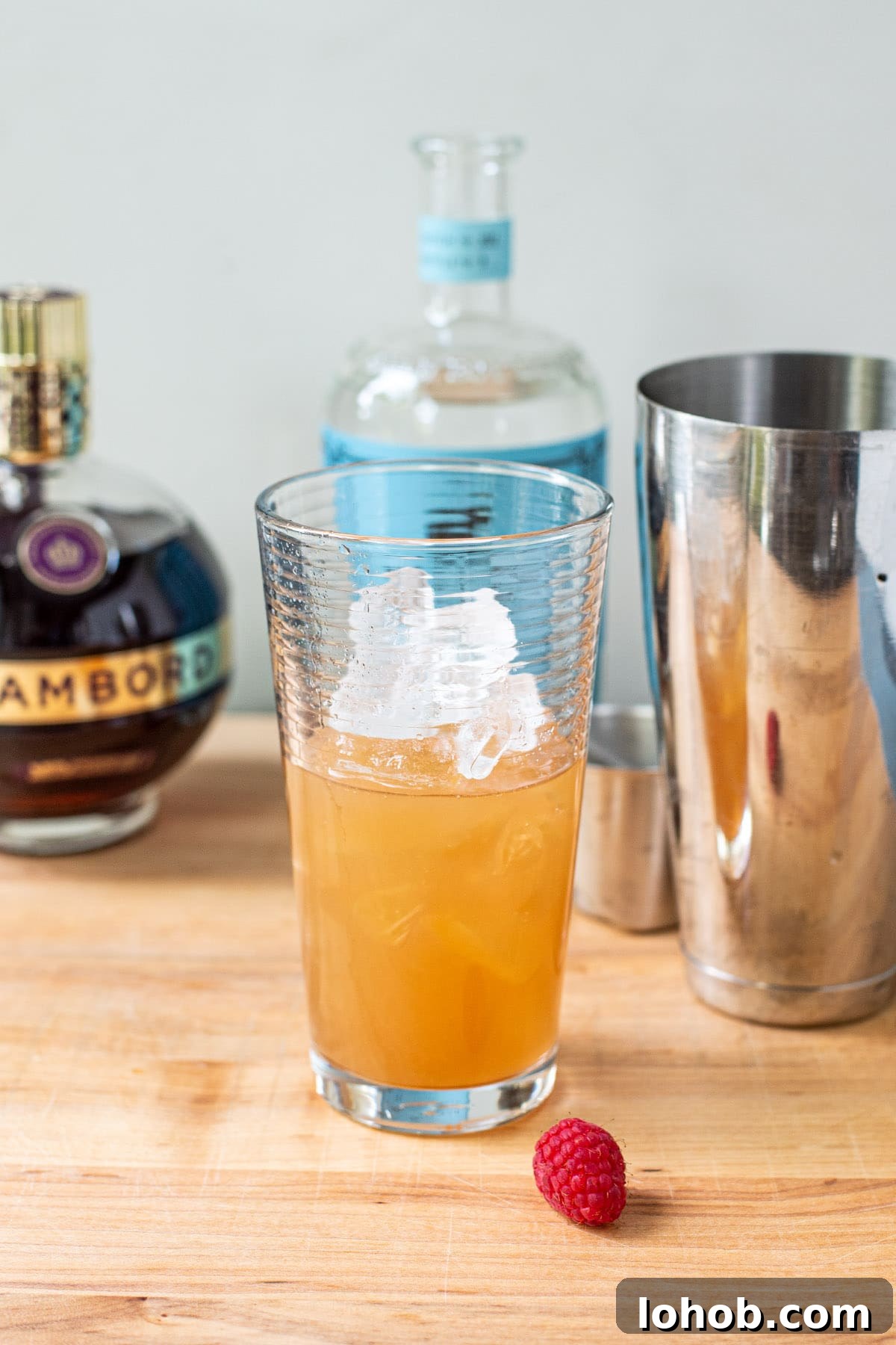 Vodka, Chambord, and pineapple juice in a clear cocktail shaker.