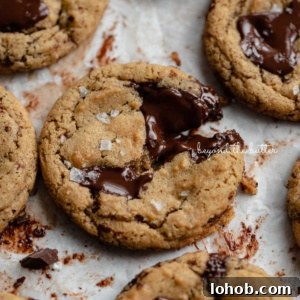 Small batch gluten-free peanut butter chocolate chunk cookies on a parchment paper lined baking sheet.