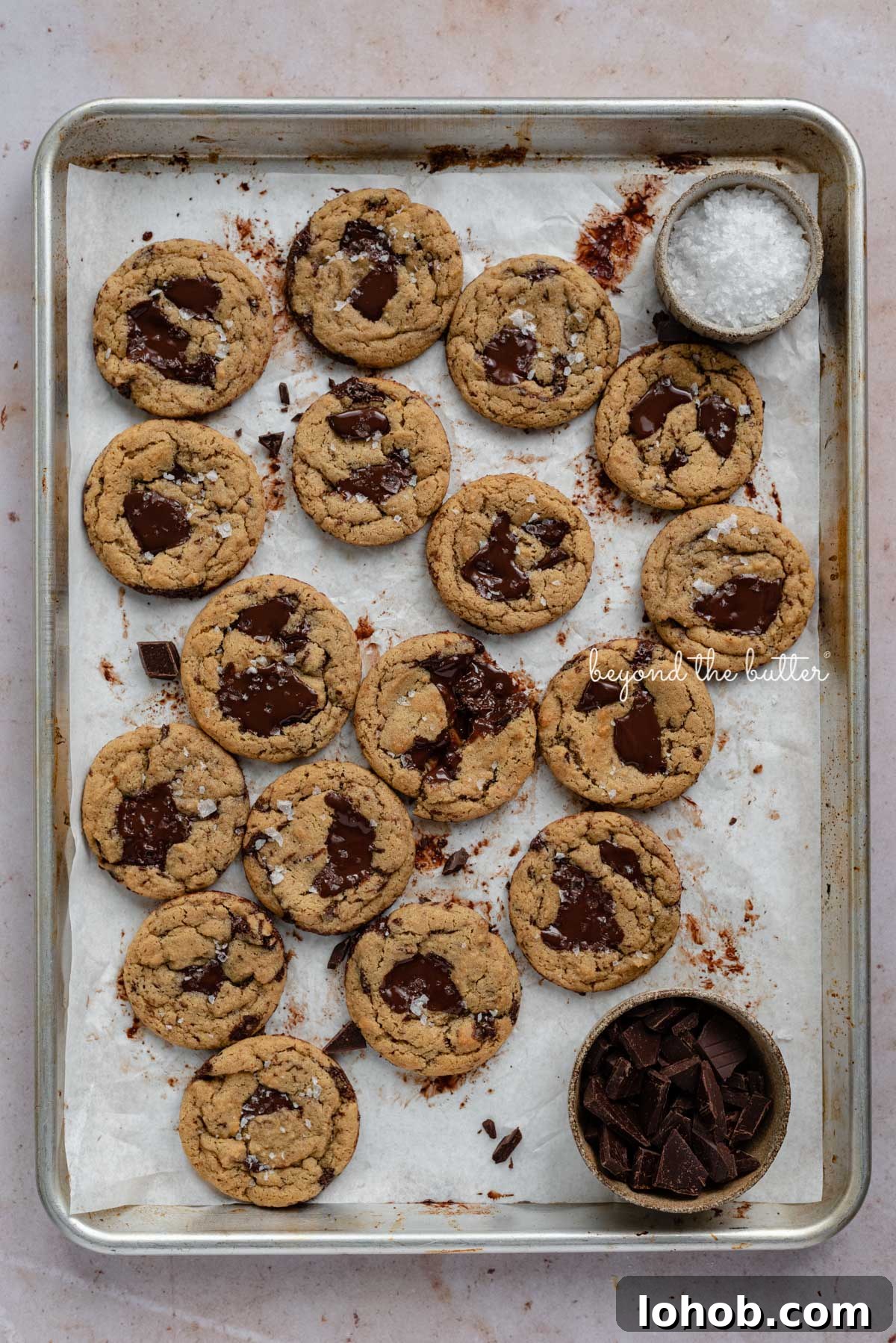 Small batch gluten-free peanut butter chocolate chunk cookies on a parchment paper lined baking sheet