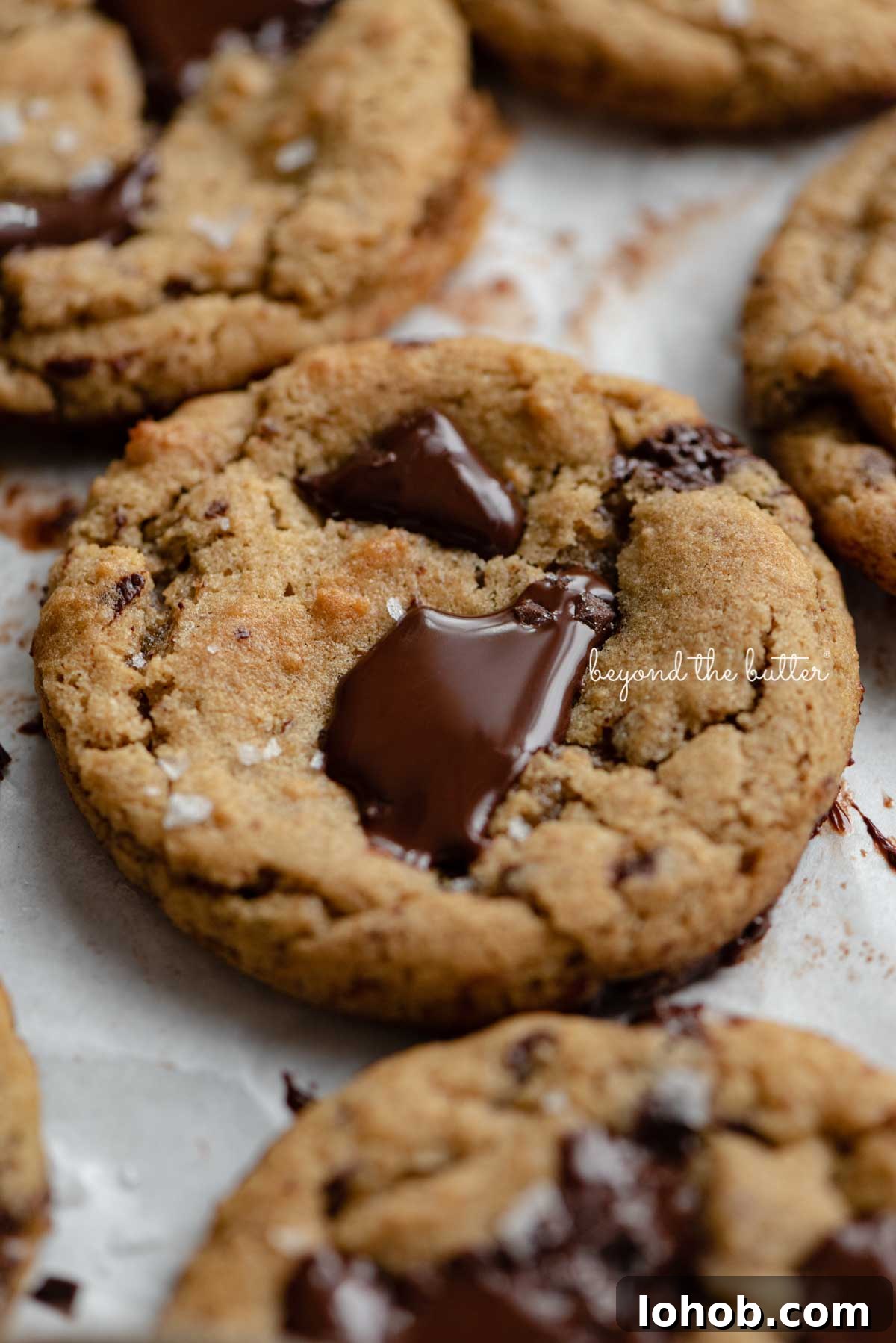 Small batch gluten-free peanut butter chocolate chunk cookies on a parchment paper lined baking sheet