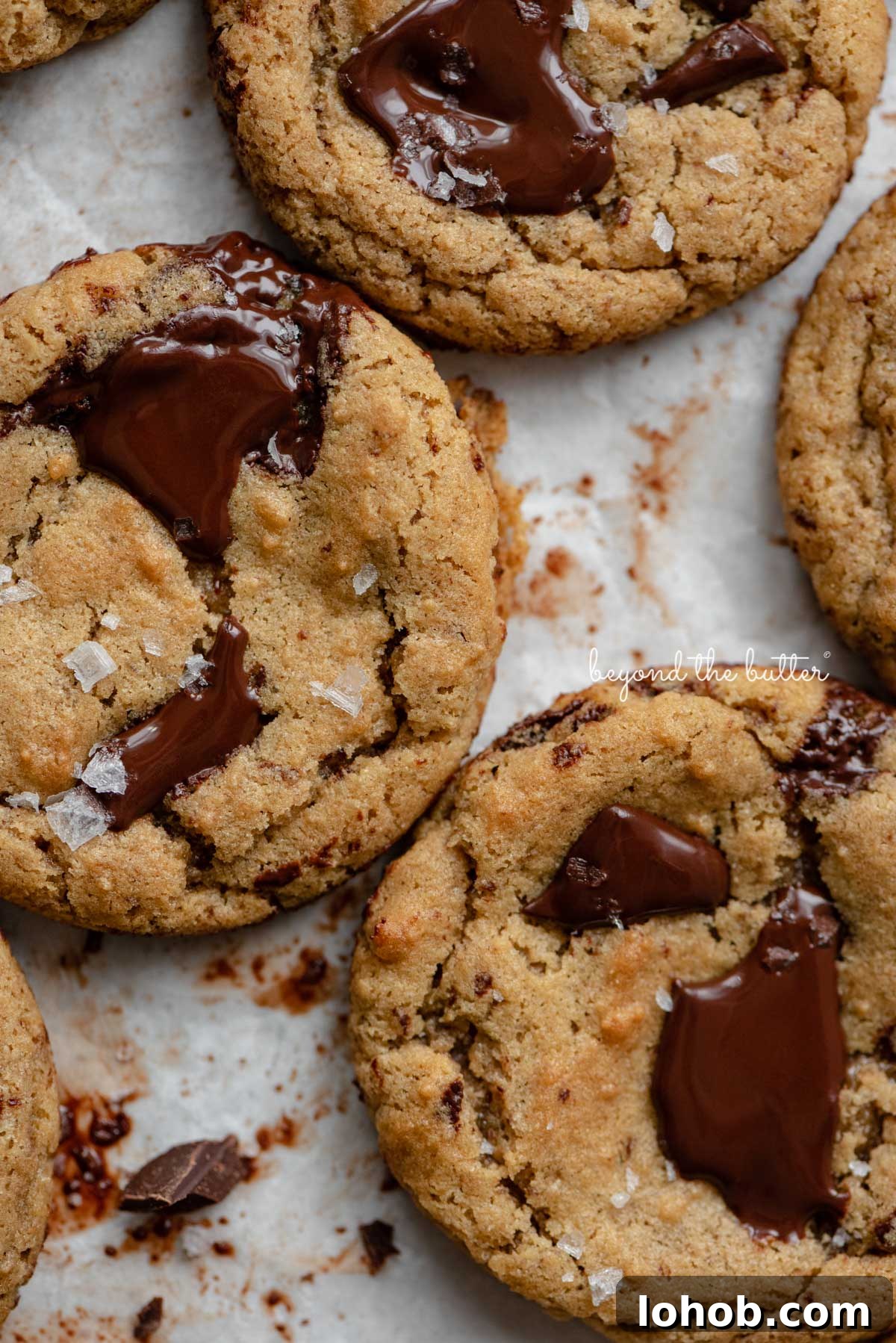 Small batch gluten-free peanut butter chocolate chunk cookies on a parchment paper lined baking sheet