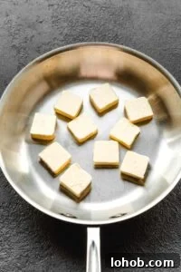 Browned Butter: Simple Step-by-Step Guide for Perfect Flavor 6 Skillet with a stick of butter cut up into pieces.