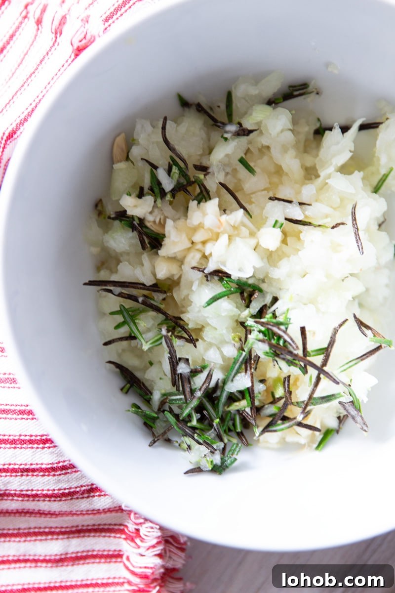 Slow Cooker Lemon Garlic Whole Chicken Recipe 4 Bowl of chopped garlic, onion, rosemary, and lemon juice.
