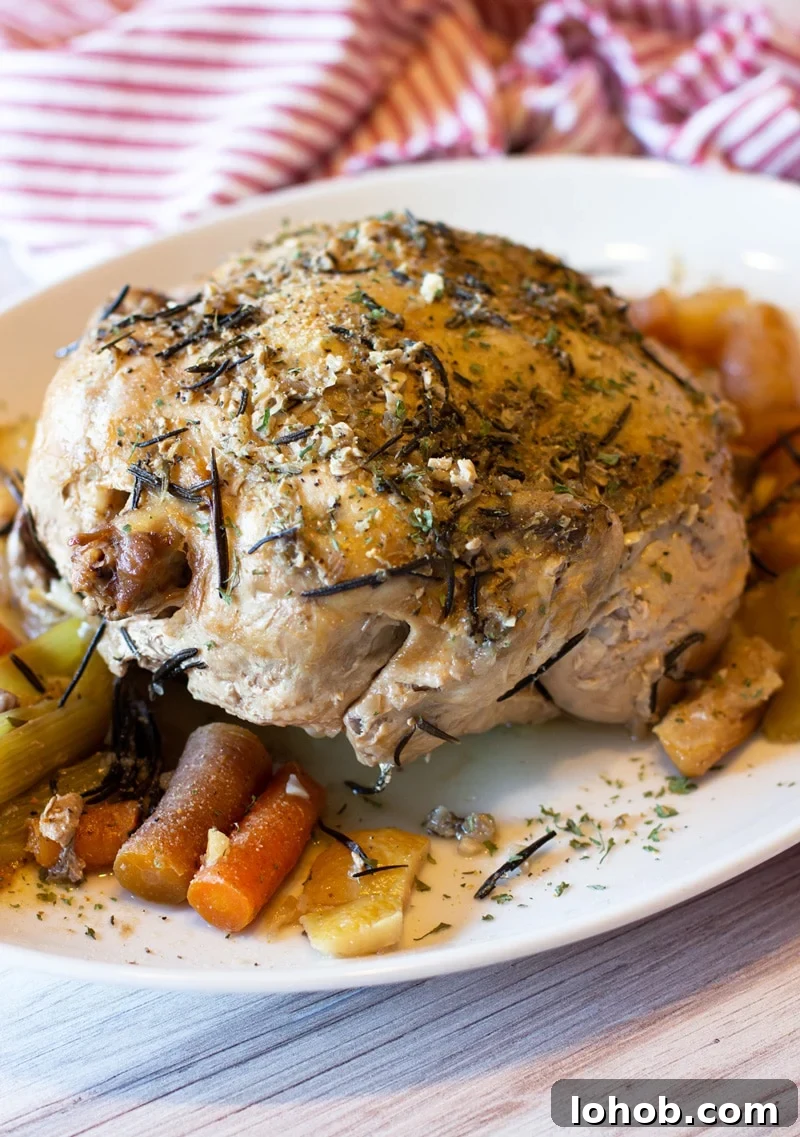 Slow Cooker Lemon Garlic Whole Chicken Recipe 8 Lemon garlic chicken sitting on a platter with carrots.