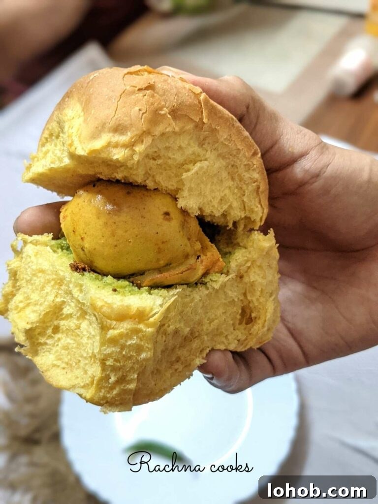 Close up of vada pav held in hand