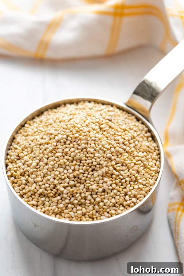 uncooked quinoa in a measuring cup for edamame quinoa salad.