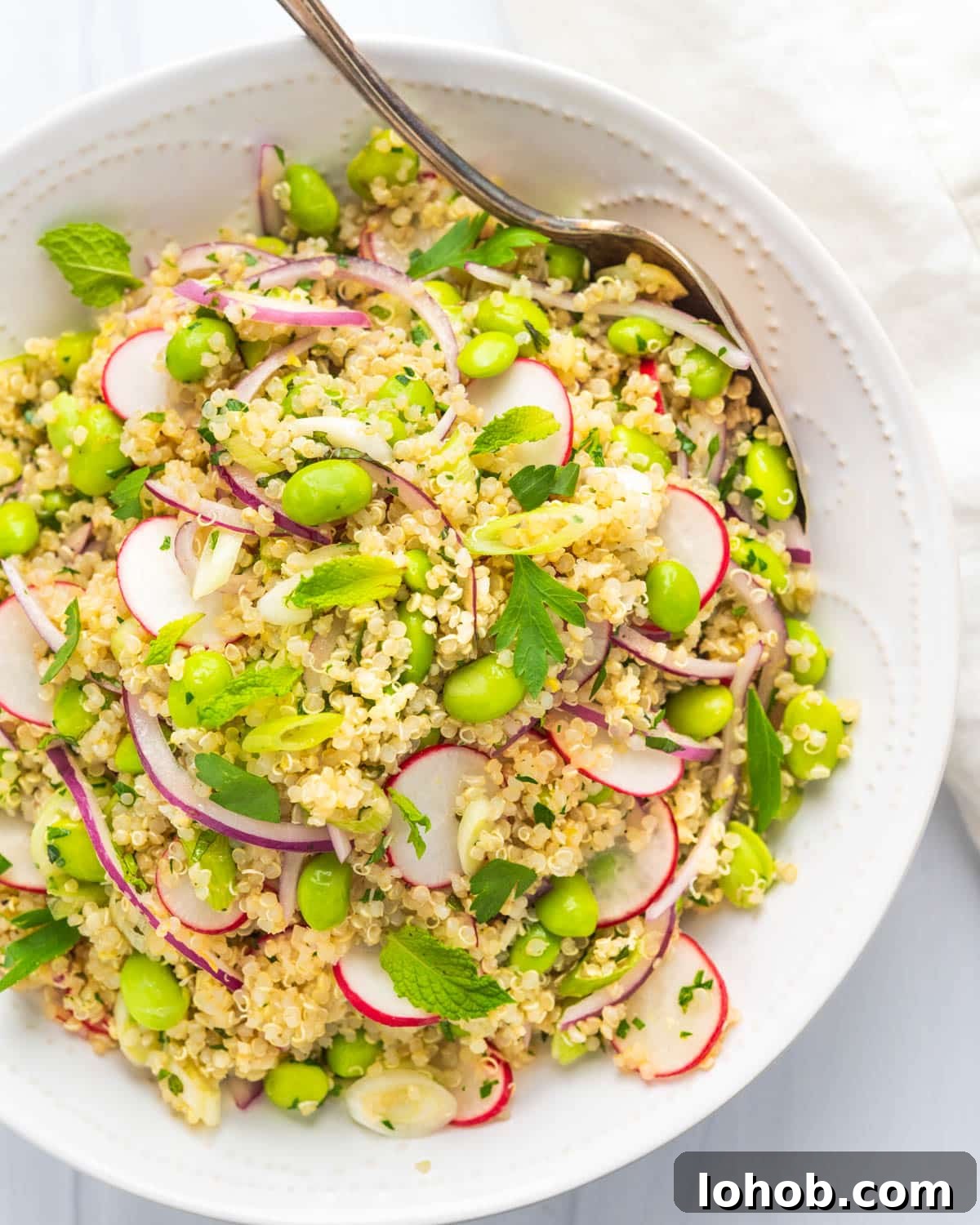 edamame salad in a white bowl.
