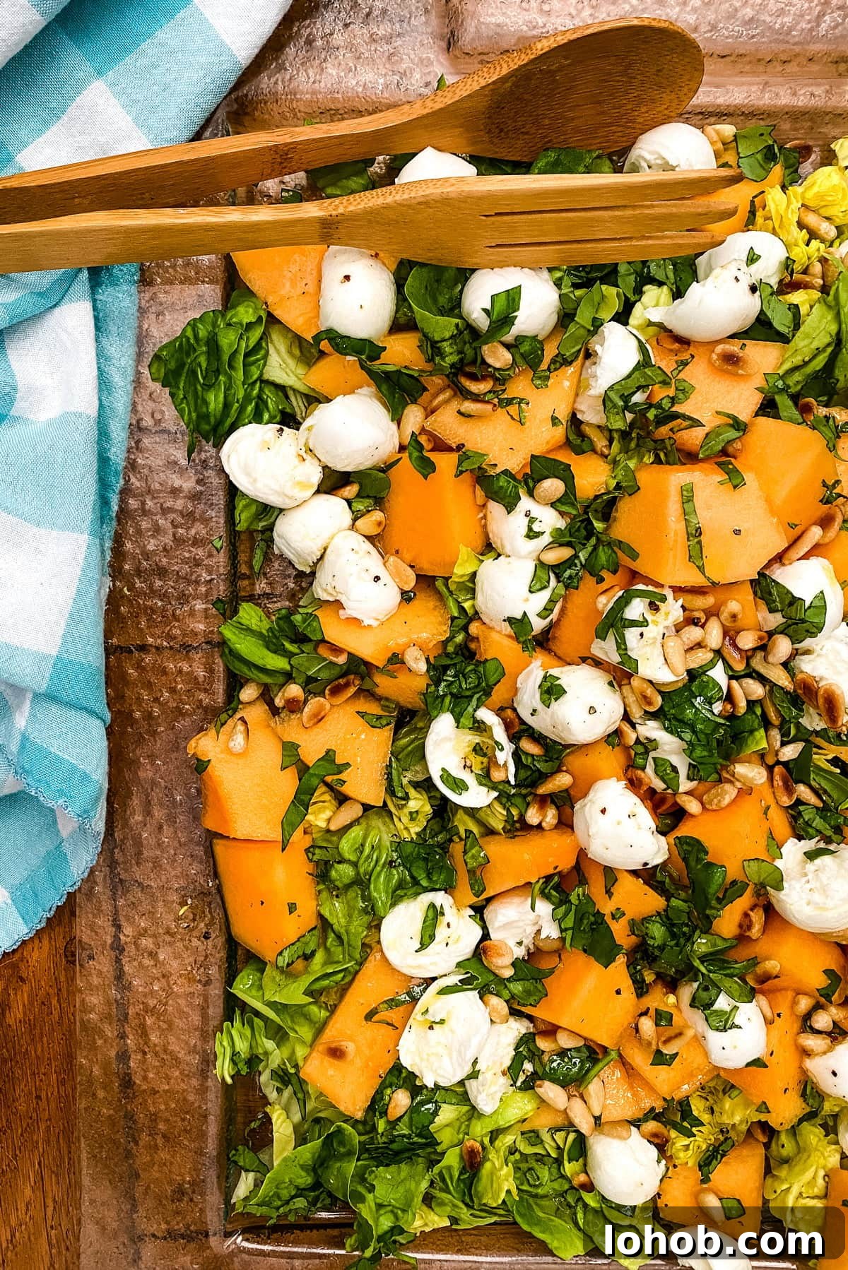 Cantaloupe and Fresh Mozzarella Salad with Toasted Pine Nuts 2 glass platter with cantaloupe, fresh mozzarella
