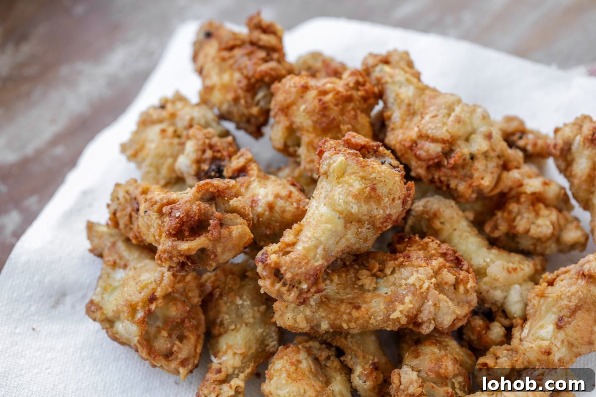 Chicken buffalo wings on a paper towel ready for coating with sauce. 