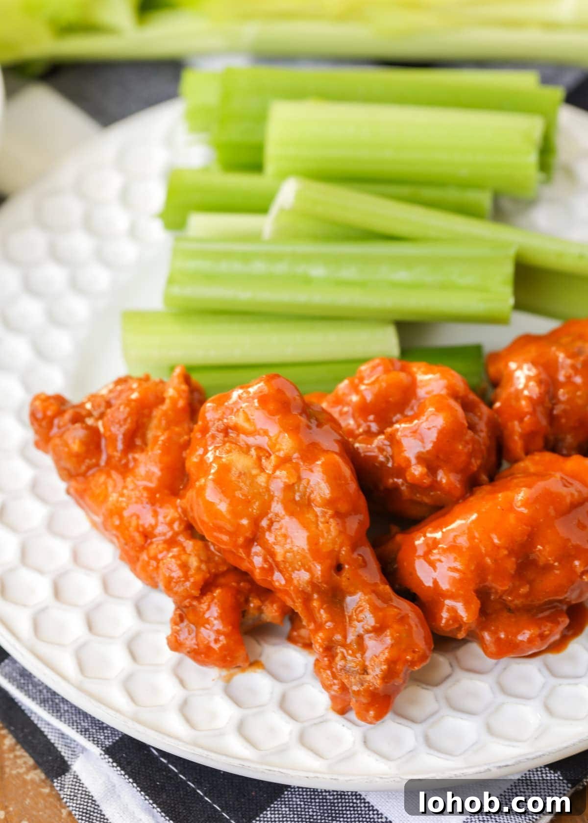 Buffalo chicken wings smothered in buffalo sauce and served with celery.