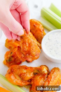 hand picking up air fryer wings