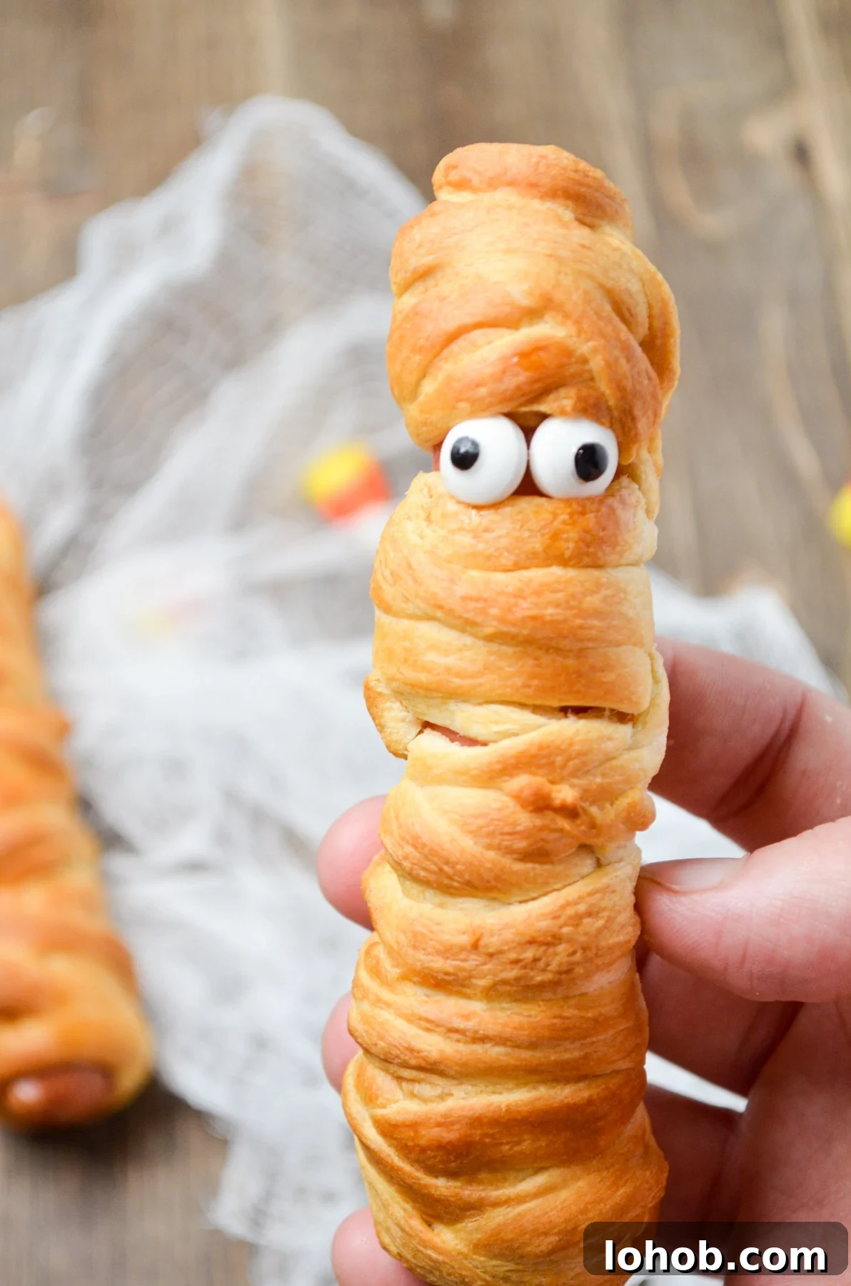 Crispy Mummy Hot Dogs for Halloween – Air Fryer & Oven Guide 3 A mummy hot dog, with candy eyes fixed onto it.