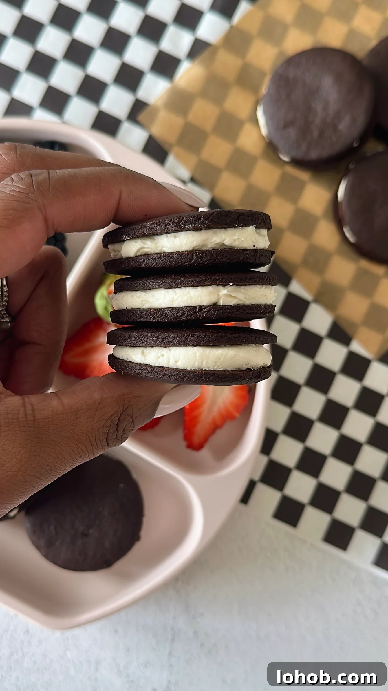 Homemade oreo cookies served with berries.
