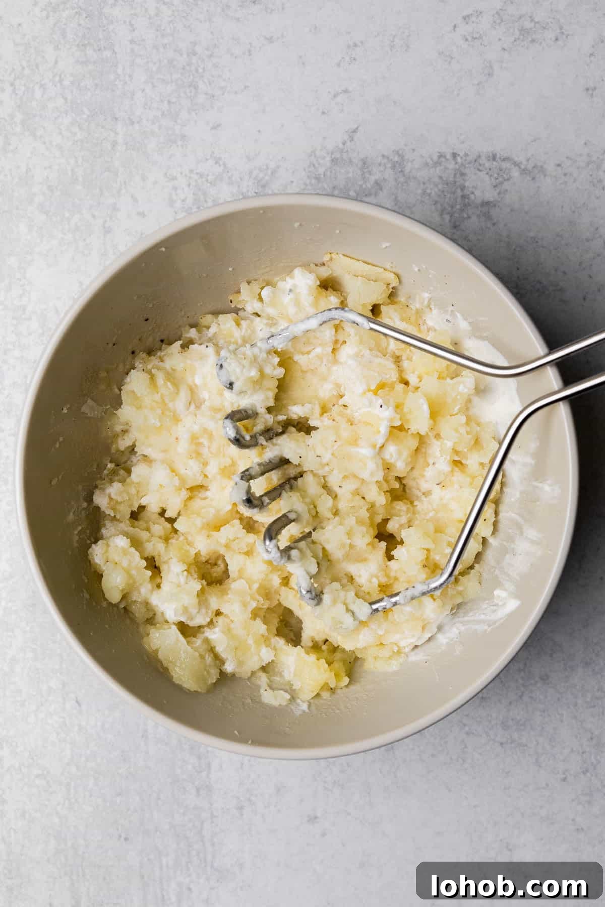 mashing the potatoes