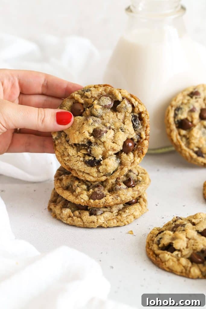 a stack of gluten-free oatmeal raisin chocolate chip cookies on a white background