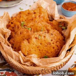 Crispy Bacalaitos: Authentic Puerto Rican Codfish Fritters 9 A basket filled with bacalaitos (or codfish fritters) sits on a countertop with napkins.