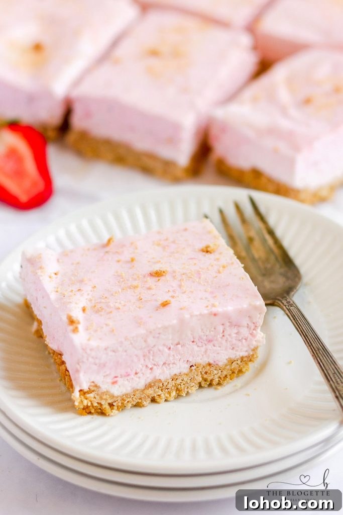 Strawberry Cheesecake Bars start with a graham cracker crust, a layer of cheesecake, and then a no-bake strawberry cheesecake layer.