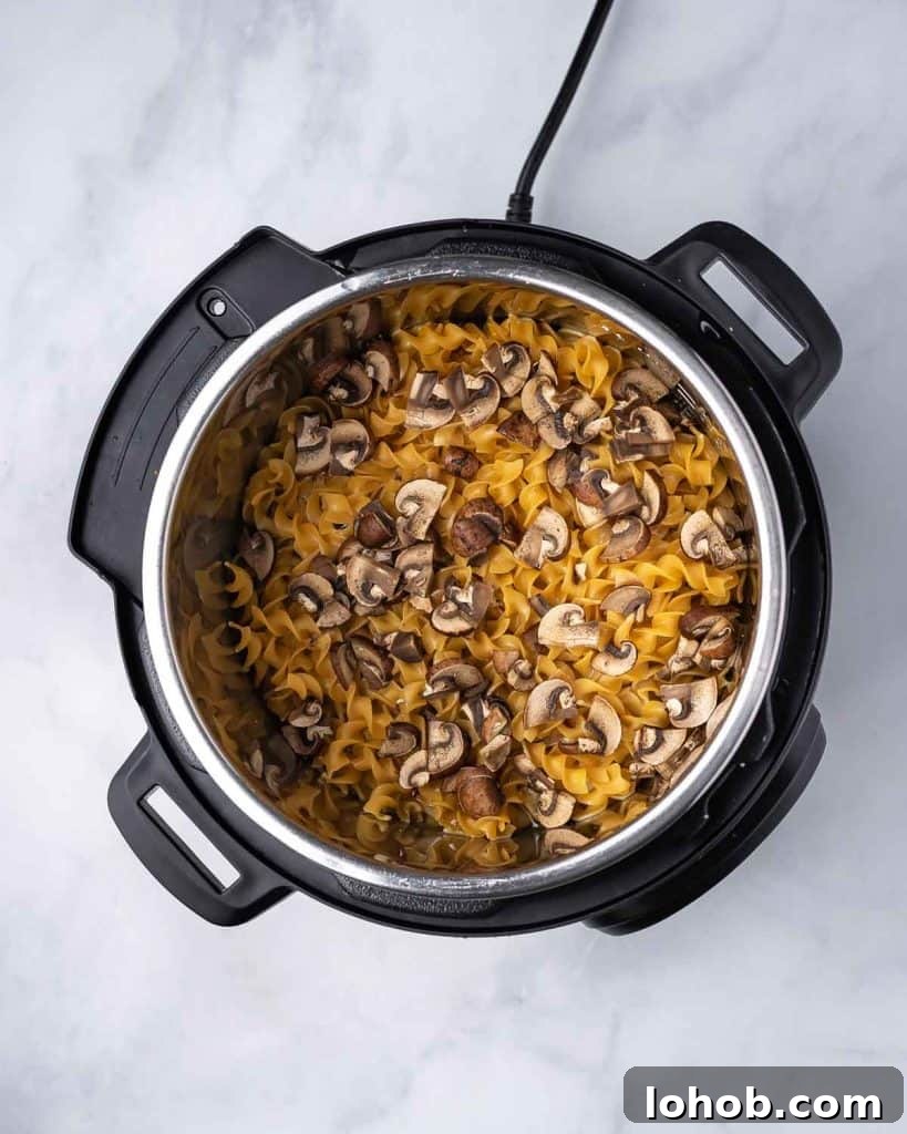 Creamy Instant Pot Chicken Stroganoff Recipe 9 Instant pot with cooked instant pot chicken stroganoff ingredients.