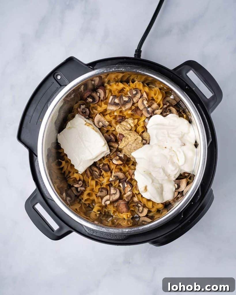 Creamy Instant Pot Chicken Stroganoff Recipe 10 Cream cheese and sour cream added to instant pot chicken stroganoff.