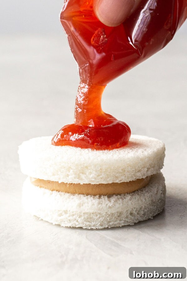 Putting jelly onto bread.