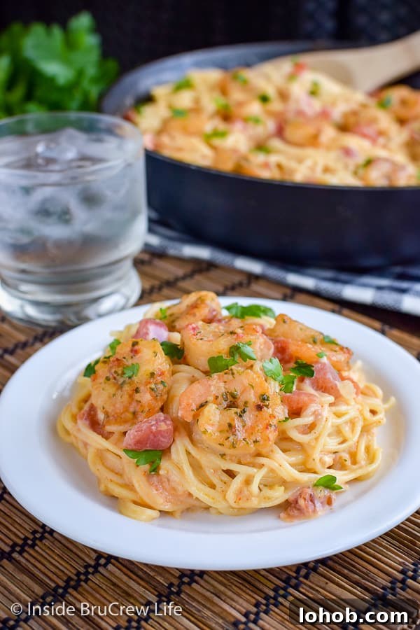 Spicy Parmesan Shrimp Scampi - a homemade cheese sauce with pasta and shrimp can be on your dinner table in under 30 minutes. Enjoy this comfort food meal on busy nights! #pasta #shrimp #shrimpscampi #easyrecipe #parmesan