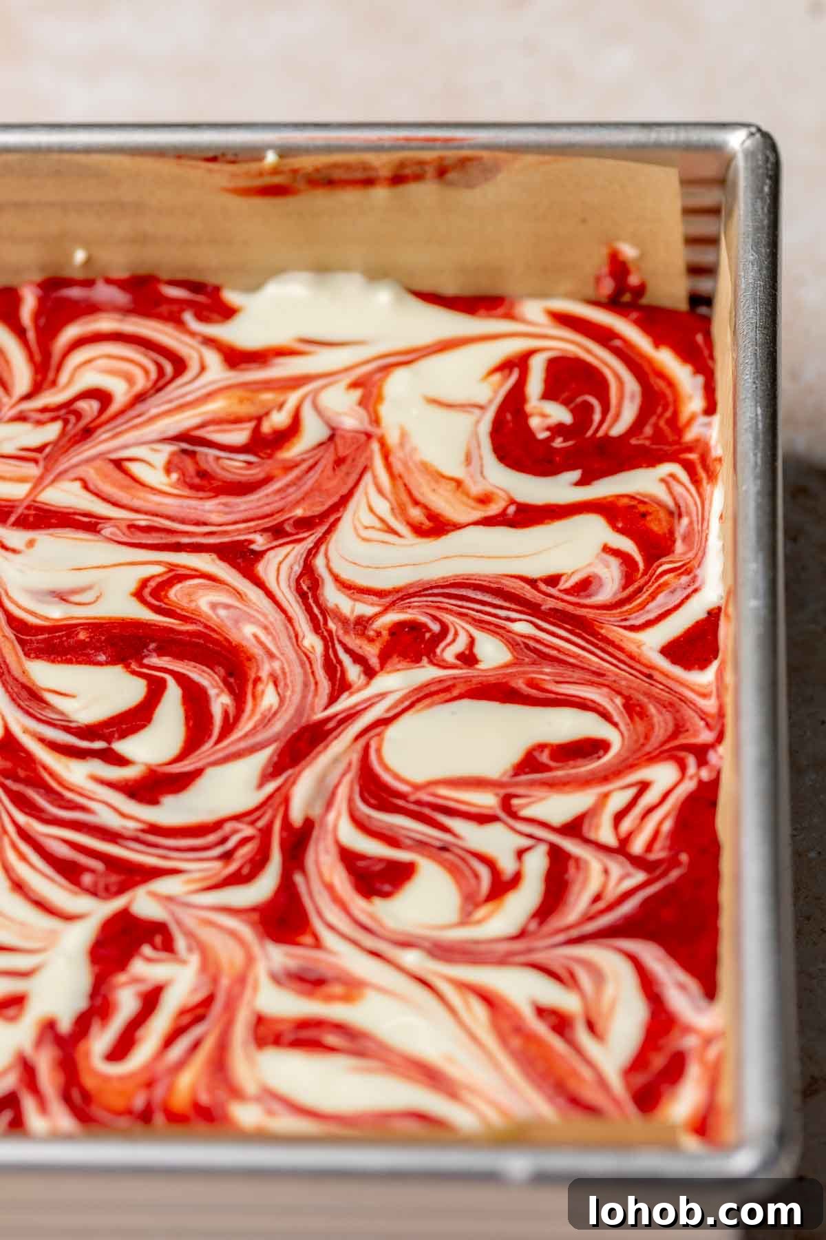 Fudgy Red Velvet Brownies with Cream Cheese Swirl 11 Swirled red velvet cheesecake brownie batter in a pan.