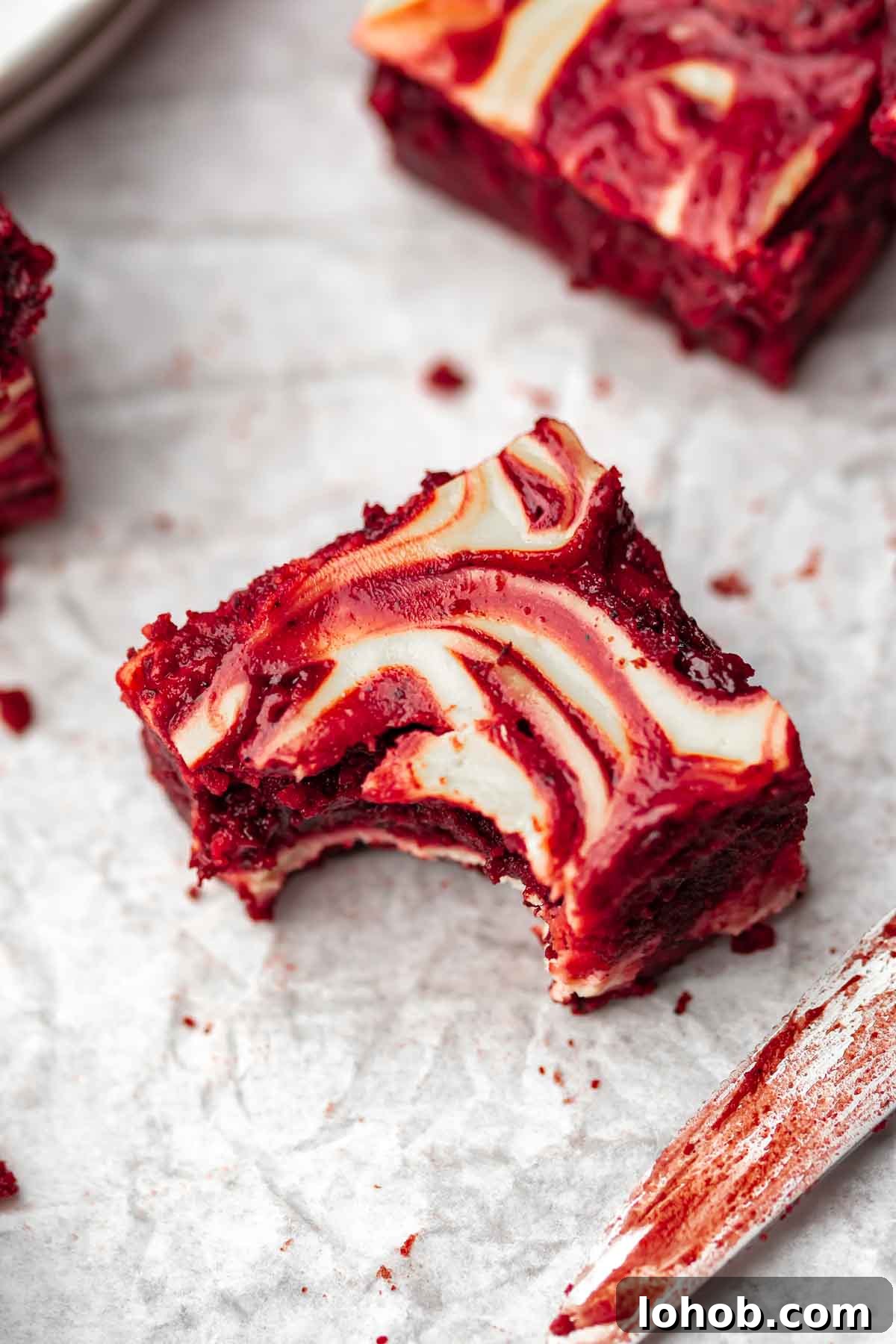 Fudgy Red Velvet Brownies with Cream Cheese Swirl 12 A red velvet brownie with a bite taken out of the corner.