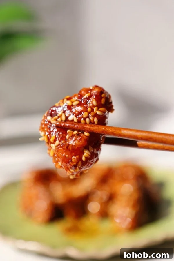 Korean Cucumber Salad (Oi Muchim) Recipe for Bold, Crunchy Flavor 11 Gochujang tofu being held by chopsticks.