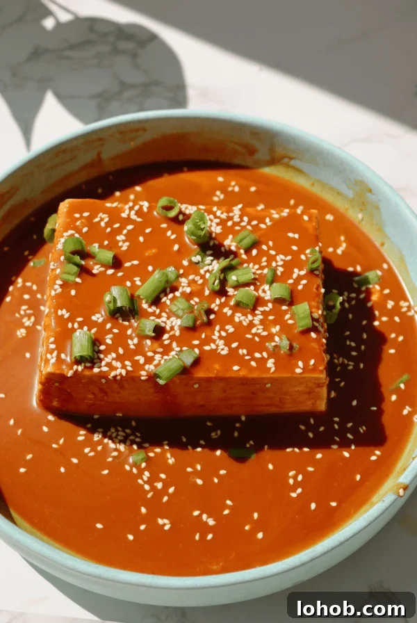 Korean Cucumber Salad (Oi Muchim) Recipe for Bold, Crunchy Flavor 12 Cold tofu recipe on a plate with sauce on top.