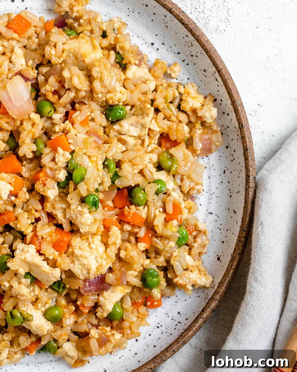 completed Easy Vegetable Brown Fried Rice plated on a white plate against a light background