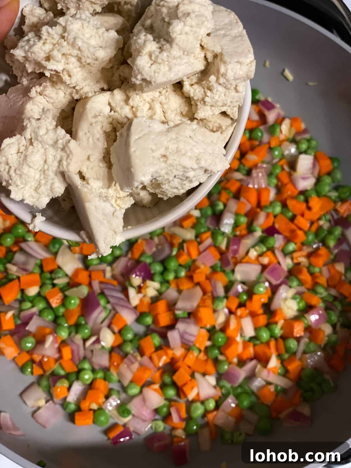 process shot of adding tofu to pan