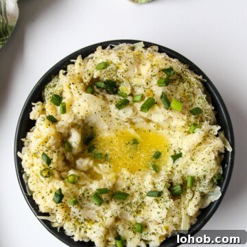 Colcannon: Traditional Irish Mashed Potatoes with Cabbage 8 Irish Mashed Potatoes in a black dish on a white table.
