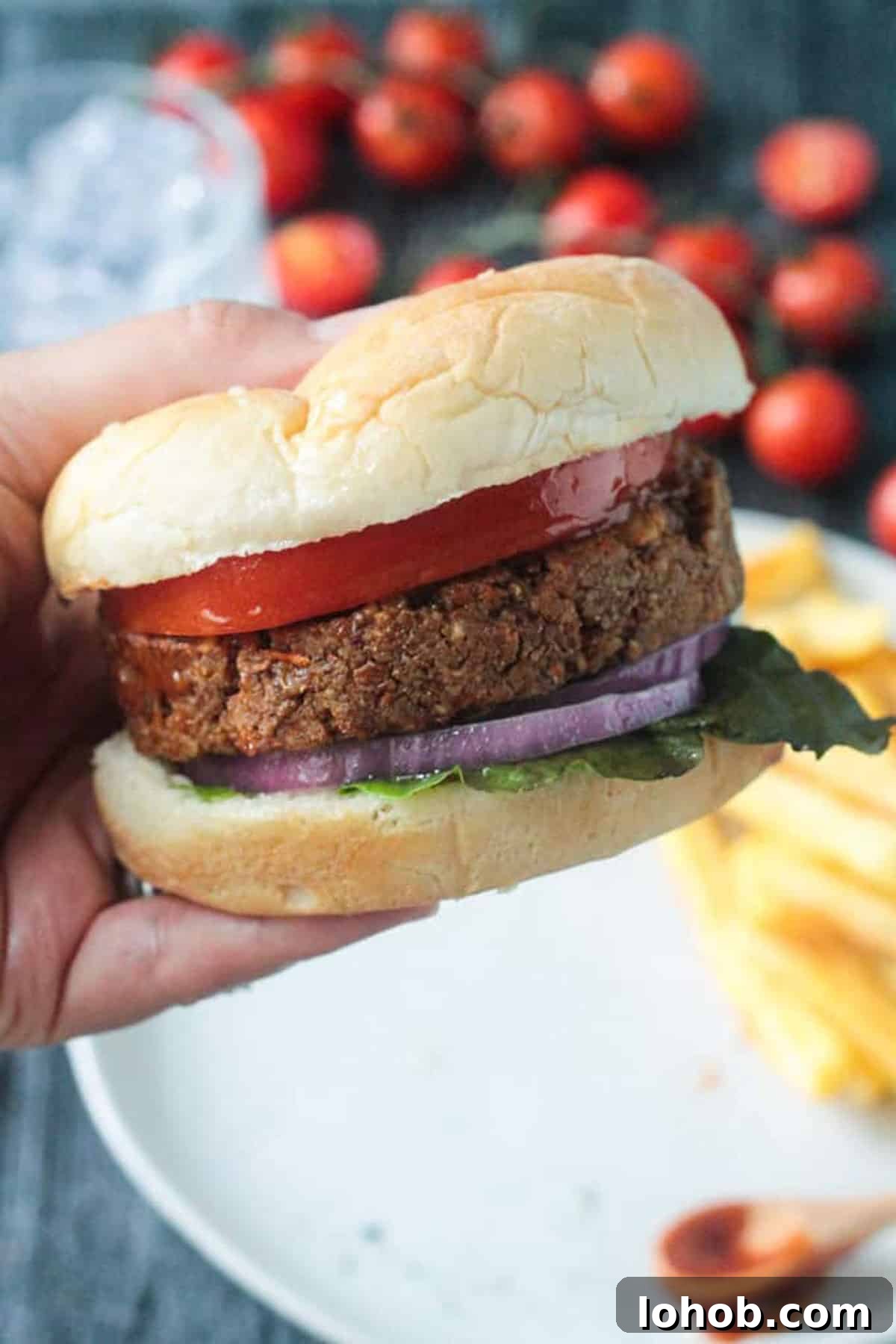 Savory Chickpea Veggie Burger Recipe for Juicy Plant-Based Patties 11 Hand holding a veggie burger.
