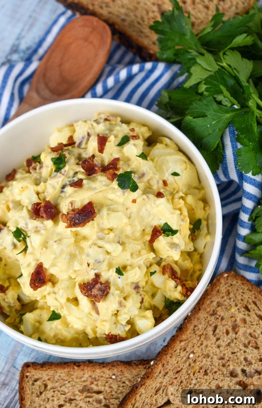 Creamy Bacon Ranch Egg Salad Recipe for Sandwiches & Bowls 2 bacon ranch egg salad in a white bowl
