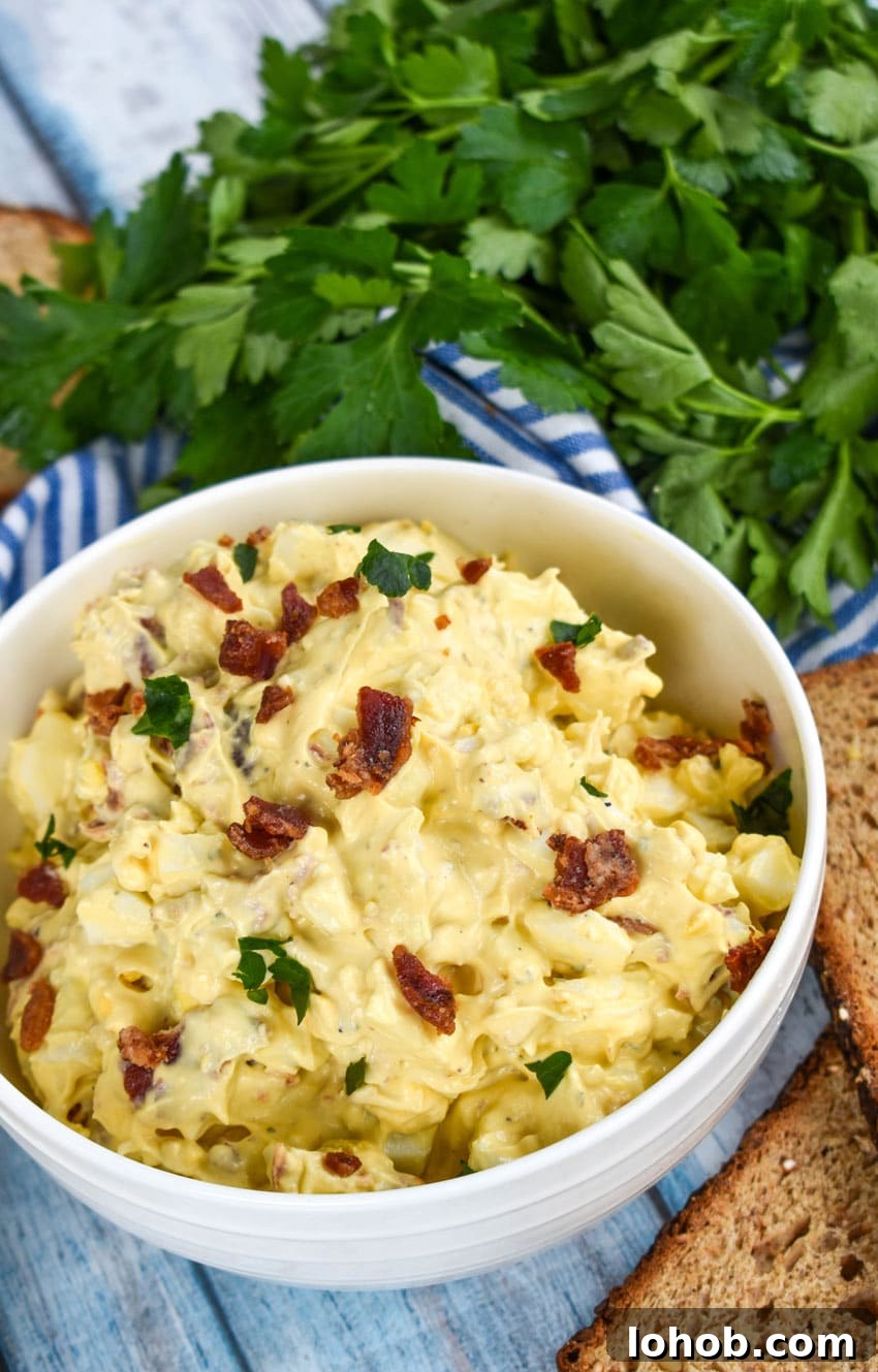 Creamy Bacon Ranch Egg Salad Recipe for Sandwiches & Bowls 3 bacon ranch egg salad in a white bowl