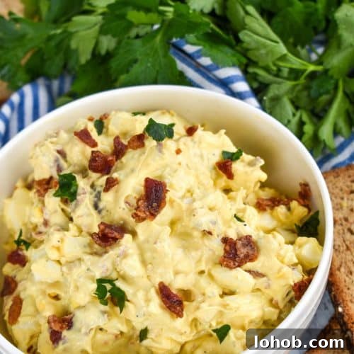 Creamy Bacon Ranch Egg Salad Recipe for Sandwiches & Bowls 7 bacon ranch egg salad in a white bowl