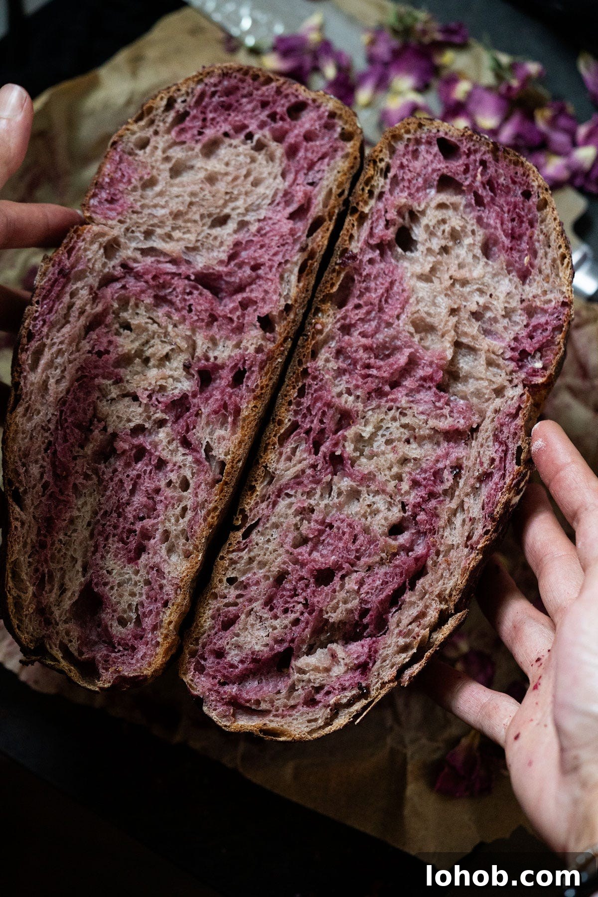 Create and Maintain a Reliable Sourdough Starter for Homemade Bread 4 A rose sugar strawberry sourdough halved showing a marbled pink crumb