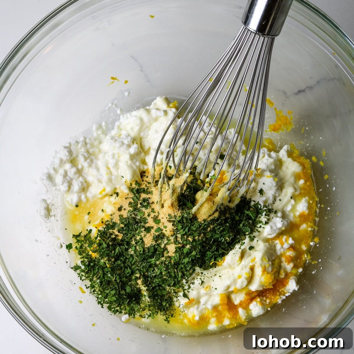 Spinach, Chicken & Artichoke Casserole Recipe with Light Cream Sauce 6 cottage cheese, lemon zest, mayo, and parsley with a whisk to the side.